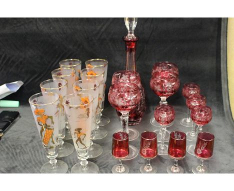 Various glassware to include ruby glass decanter, hock glasses and a set of eight 1950,s glasses with Caribbean figures