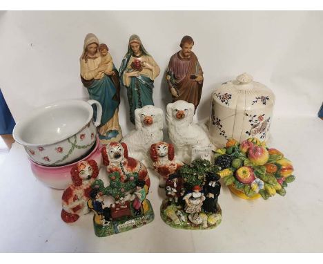 A quantity of assorted ceramics to include; religious figures a Wedgwood Tutankhamun figure, Staffordshire dogs, Beswick figu