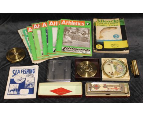 A mixed lot of anglers guides and athletics guides, a Larry Adler Junior Model harmonica, a margaret rose compact, a yardley 