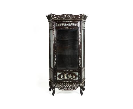 A GLAZED MOTHER OF PEARL INLAID DISPLAY CABINET With carved and pierced waved pediment of dragons above three glazed windows 