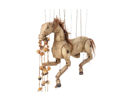 A LARGE CARVED WOOD HORSE PUPPET
With articulated head, legs and hoofs
66cm high
Condition: For a condition report or further