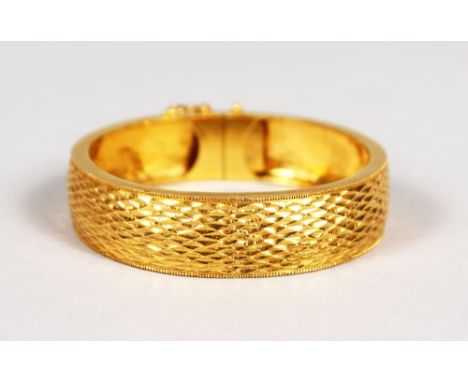 A CHINESE GOLD BANGLE. 40gms.  In Hong Kong box.