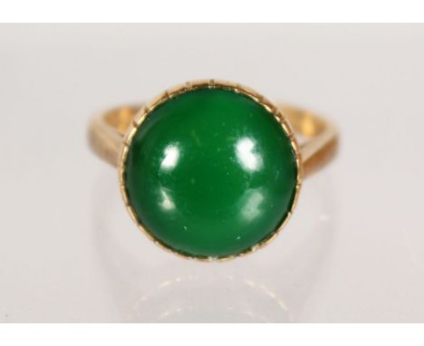 A GOLD JADE RING.