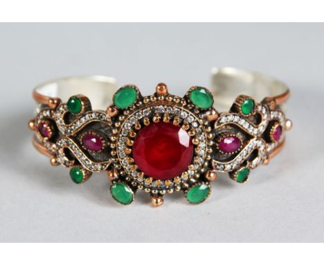 A SILVER AND GILT RUBY SET BANGLE.