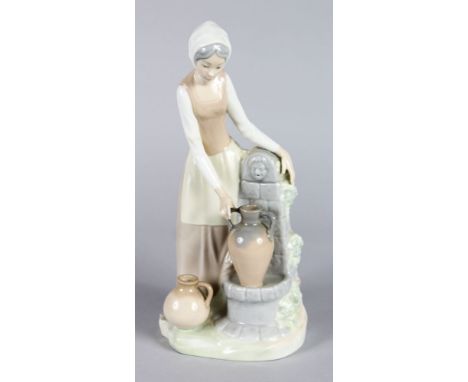 A NAO PORCELAIN FIGURE OF A YOUNG GIRL collecting water at a well.  12ins high.