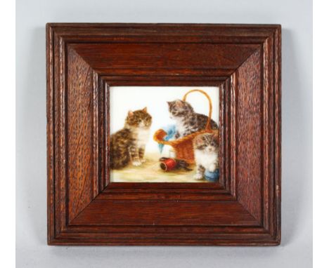 AFTER BESSIE BAMBER A SUPERB SMALL ENAMEL PLAQUE OF THREE PLAYFUL KITTENS, one in a basket, 3ins x 3.5ins, in a wooden frame.