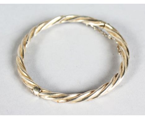 A SILVER ROPE BANGLE.