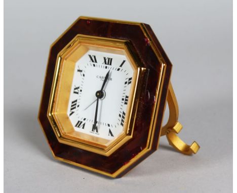 A GOOD CARTIER OCTAGONAL EASEL CLOCK in a red Cartier pouch.