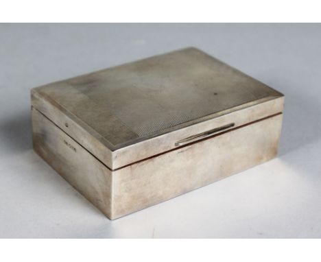 AN ENGINE TURNED CIGARETTE BOX with cedar wood liner. 4.25ins long. Sheffield 1960.