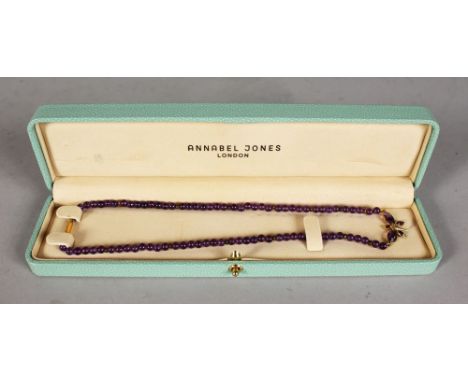 A FINE ANNABEL JONES AMETHYST BEAD NECKLACE with butterfly clasp, in a leather case.