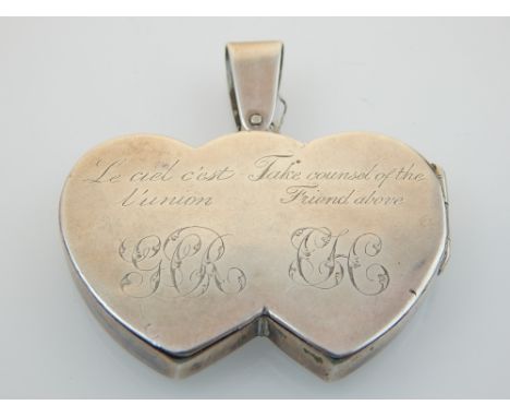 A silver double heart portrait pendant the hinged back with engraved dedication.