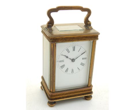 A 20th century carriage timepiece, the corniche case with blind pierced bands and raised on short bun feet, the white enamel 