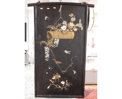 An early 20th century Chinese bone inlaid acquer screen depicting a hanging bamboo gong before a spray of blossom and peony w