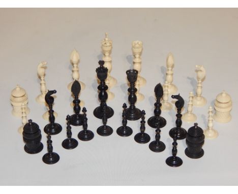 An early 20th century Anglo Indian stained and natural ivory chess set, with fine carved decoration on slender baluster stems