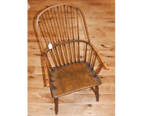 An early 19th century South West region Windsor elm and fruitwood comb back elbow chair, with solid burr seat on turned under