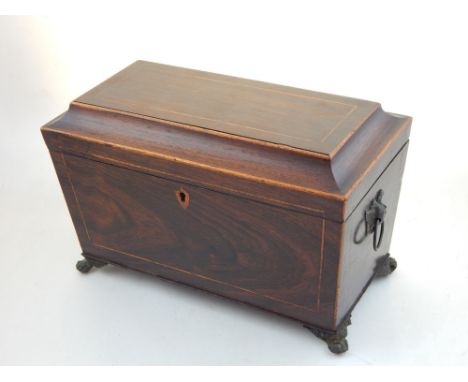 A George III satinwood banded, boxwood strung mahogany sarcophagus tea caddy with twin lidded interior on cast lions paw feet