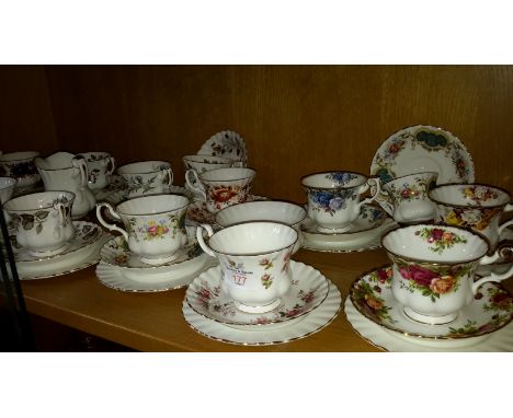 Shelf of Royal Albert trio's 