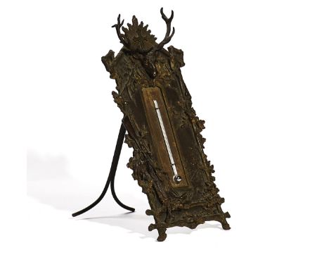 A BRASS DESK THERMOMETERProbably German, Late 19th CenturySurmounted with a cross behind stag's head depicting the crest of S