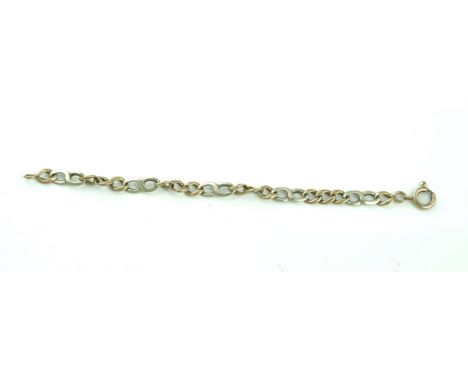 A TWO COLOUR GOLD BRACELETIn a curb and twist link design, on a boltring clasp, detailed 9 K, weight 17.6 gms
