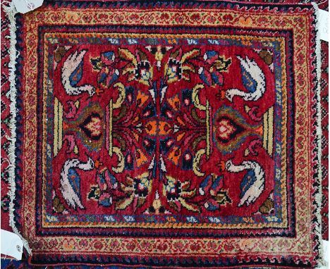 AN AFRICAN FLAT WEAVE WITH BANDED MADDER AND BLACK AND WHITE DECORATION (3)Along with a Saraband rug, the madder field with a