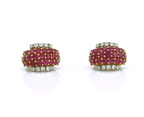 A PAIR OF GOLD, RUBY AND DIAMOND EARCLIPSEach in a curved design, mounted to the centre with three rows of circular cut rubie