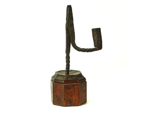 AN ENGLISH WROUGHT IRON RUSH-LIGHT HOLDER18th CenturyMounted on an octagonal walnut plinth, 23cm highCondition report:&nbsp;S