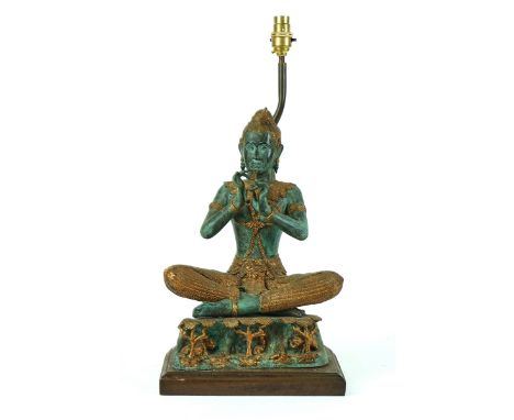 A PATINATED &amp; GILT BRONZE MODEL OF A THAI MUSICIAN20th CenturyMounted on a wooden base with a light fitting for use as a 