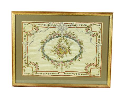 A GEORGE III SILK EMBROIDERED PANELCirca 1780Depicting a bouquet of flowers within a ribbon tied oval cartouche and truncated