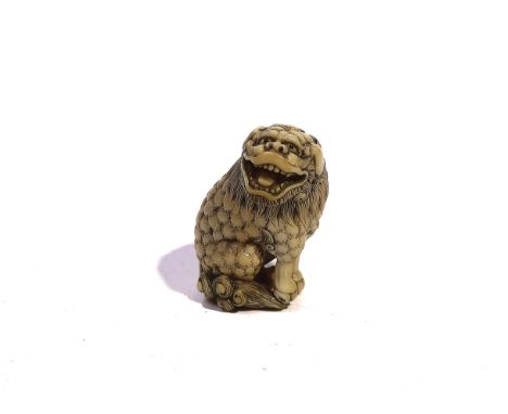 A JAPANESE IVORY NETSUKE OF A SHISHIMeiji periodCarved seated on its haunches, its head turned toward the right, signed Masay