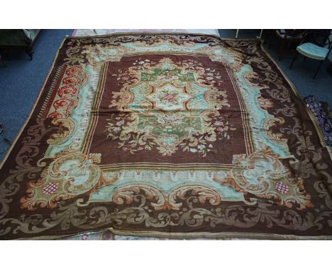 AN AUBUSSON CARPETA large Aubusson tapestry carpet, the brown square field with a large cartouche bearing floral sprays and b