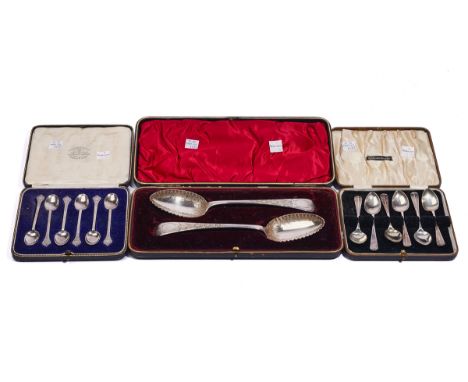 THREE CASED SETS OF SILVER FLATWARE (3)Comprising; a pair of dessert serving spoons with floral and foliate engraved decorati