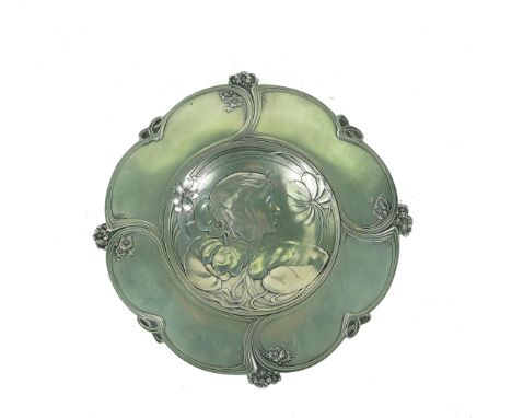 AN ART NOUVEAU PEWTER WALL PLAQUE (2)Circa 1910Of dished form with low relief profile of a lady's head emerging from a lily p