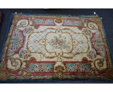 A PAIR OF EUROPEAN CARPETS OF AUBUSSON DESIGN (2)The ivory field with a central floral bouquet within leaf scrolls, a shaped 