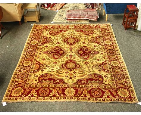 A MODERN AFGHAN CARPETThe light brown field with four bold palmette medallions, supporting side medallions; a complementary r