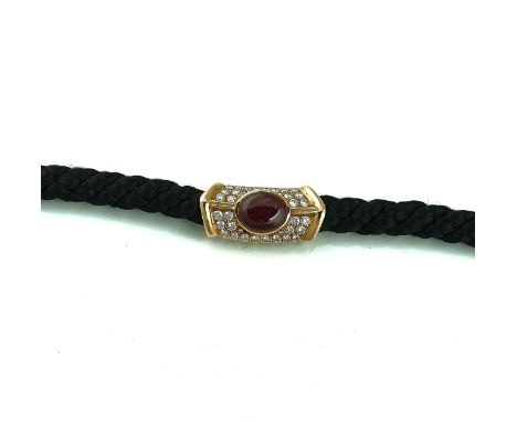 A DAVID MORRIS DIAMOND AND RUBY SET NECKLACEThe front mounted with an oval cabochon ruby, otherwise set with circular cut dia