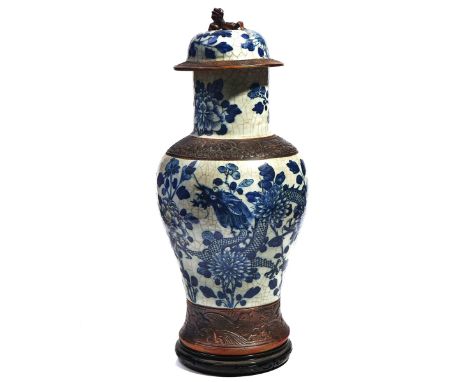 A CHINESE BLUE AND WHITE CRACKLE GLAZED VASE AND COVERLate 19th centuryOf baluster form, painted with dragons amongst flowers