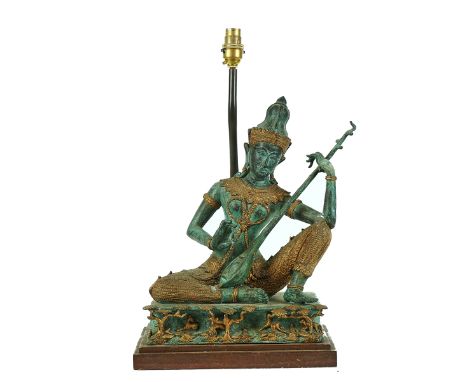 A PATINATED &amp; GILT BRONZE MODEL OF A THAI MUSICIAN20th CenturyMounted on a wooden base with a light fitting for use as a 