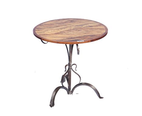 A CIRCULAR SPECIMEN WOOD INLAID OCCASIONAL TABLEOn wrought iron base, detailed to the underside ‘Fawley Court, May 2008, Firs
