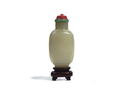 A CHINESE JADE SNUFF BOTTLEOf rounded rectangular form, the stone of pale celadon tone, 5.75cm, stopper, wood standProvenance