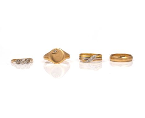 A DIAMOND THREE STONE RING AND THREE FURTHER RINGS (4)Comprising; a gold and platinum three stone diamond ring, mounted with 