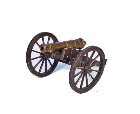 A BRONZE MODEL CANNON ON FIELD CARRIAGEEarly 20th CenturyThe 55cm barrel stamped 'SSS' and mounted on a wooden carriage, with