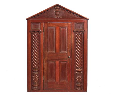 AN EARLY 19TH-CENTURY MAHOGANY AND TEAK MINIATURE DOOR FACADEWith architectural pediment over four panel door flanked by spli