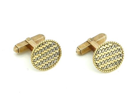 A PAIR OF TWO COLOUR GOLD CUFFLINKSEach of oval woven design, within a ropetwist border, the backs with folding sprung bar fi