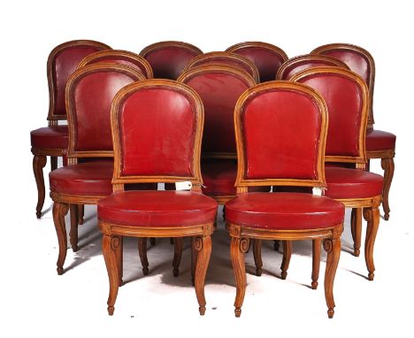 A SET OF TWELVE BEECH FRAMED LOUIS XVI  STYLE, RED LEATHER UPHOLSTERED DINING CHAIRS (12)On sabre supports, 50cm wide; 92cm h