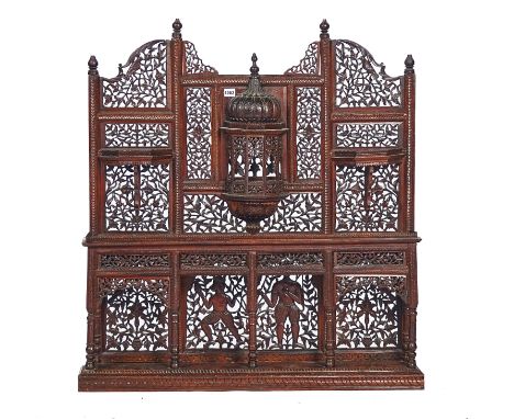 A  LATE 19TH / EARLY 20TH CENTURY NORTH INDIAN PIERCED AND CARVED HARDWOOD WALL SHELFWith an arrangements of shelves and nich