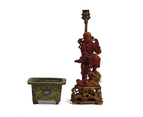 A CHINESE SOAPSTONE FIGURE OF LIU HAICHANLate 19th/20th centuryCarved standing holding a string of cash, a toad seated below,