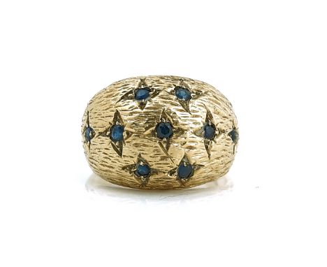 A 9CT GOLD AND SAPPHIRE RINGIn a bombe design, having a bark textured finish, ring size L, London 1974, gross weight 7.3 gms