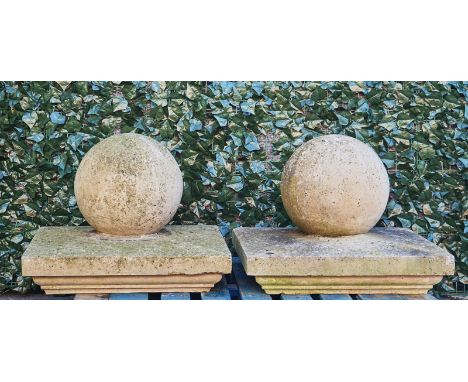 A PAIR OF GATE PIER SPHERES (2)On stepped square bases, the base, 69cm wide, total height 55cm high.