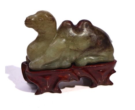 A CHINESE JADE FIGURE OF A CAMELPossibly 17th/18th centuryCarved in recumbent pose with legs tucked under the body, the stone