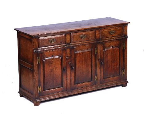 AN 18TH CENTURY STYLE OAK DRESSER BASEWith three drawers over cupboards 139cm wide; 84cm highTop with minor water marks, stru
